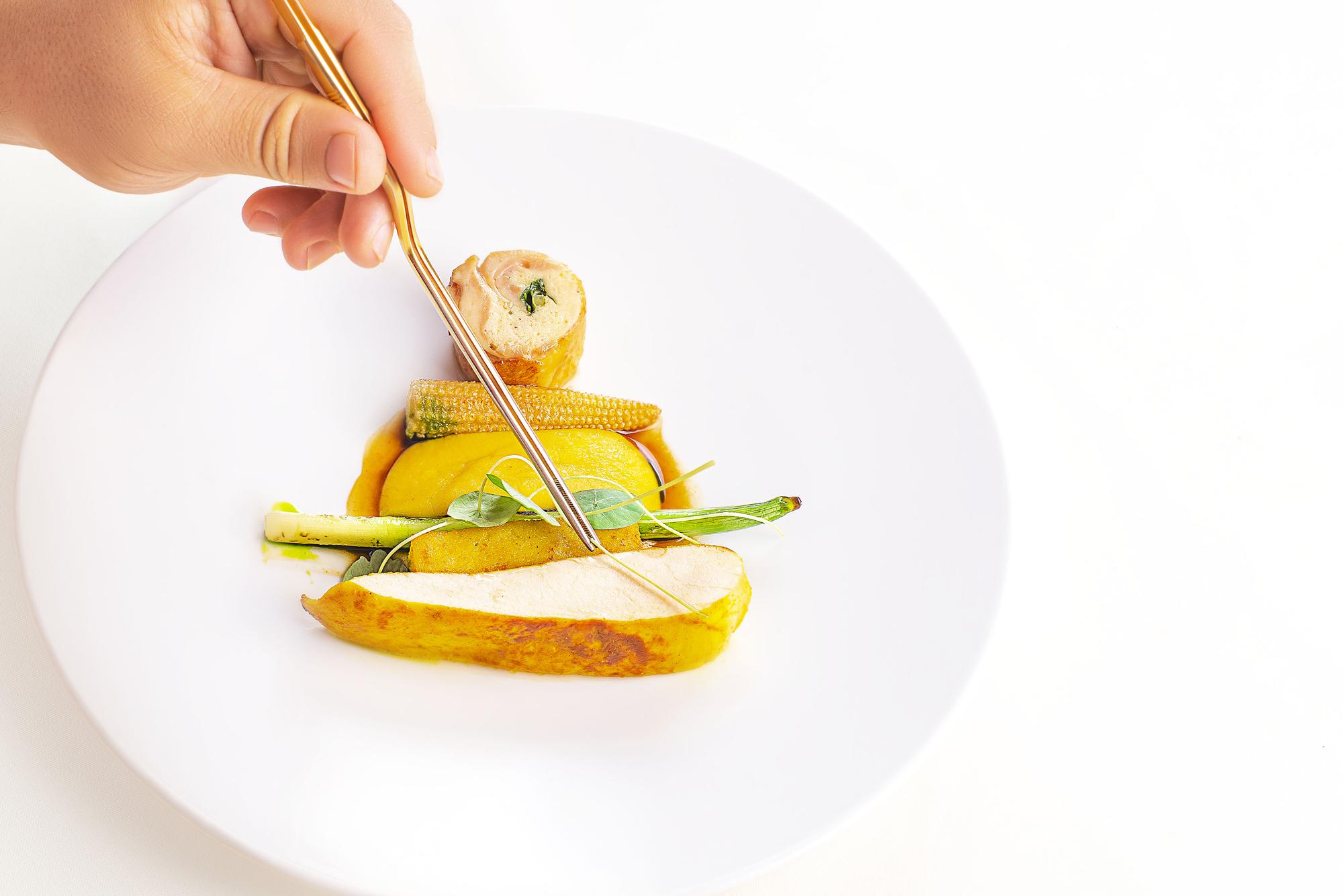 Chef plating a colorful modern dish